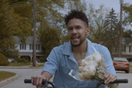 Moses Mosima takes a floral bike ride in the “Full Bloom” video