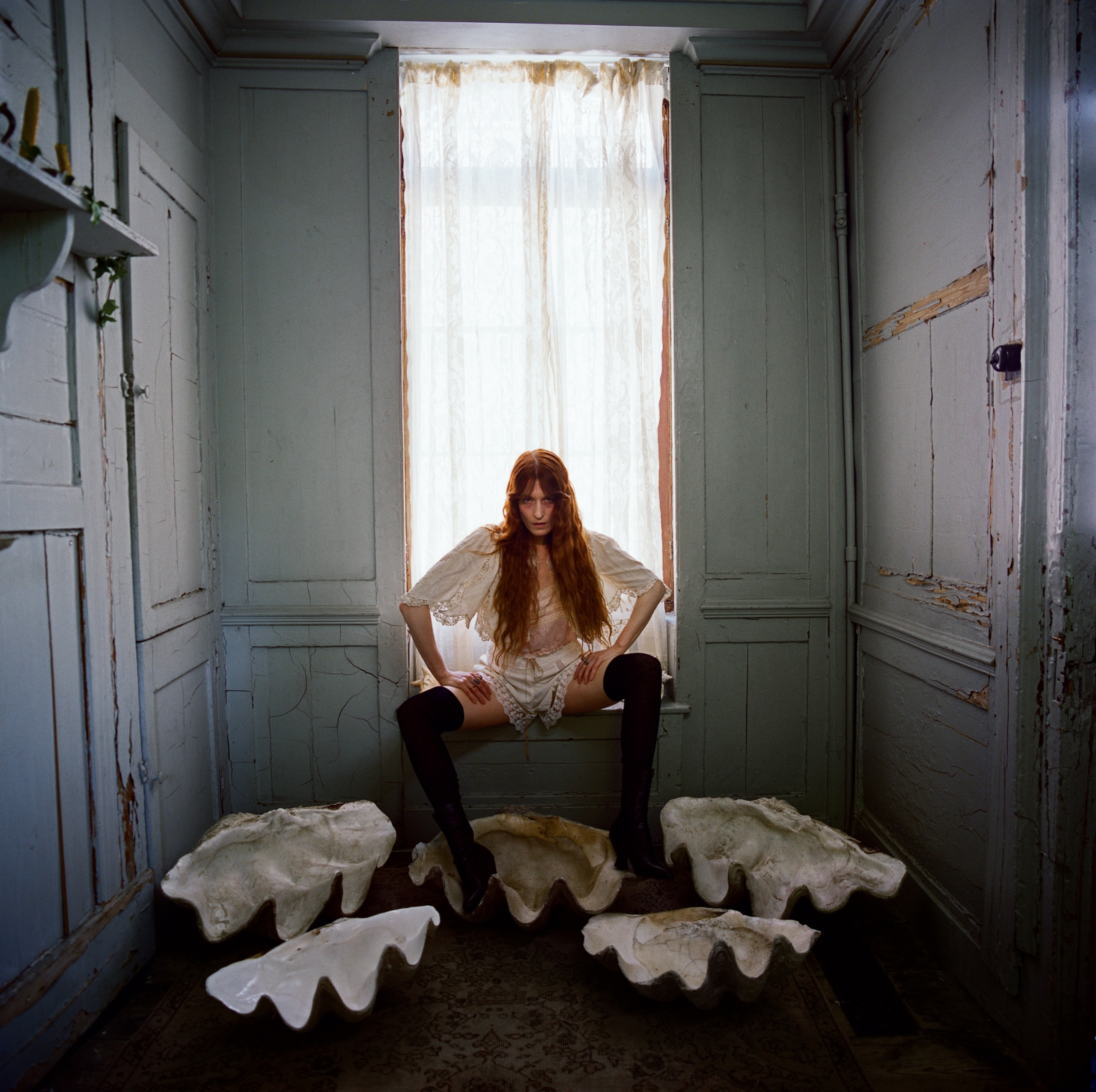 A woman sitting in a dimly lit room