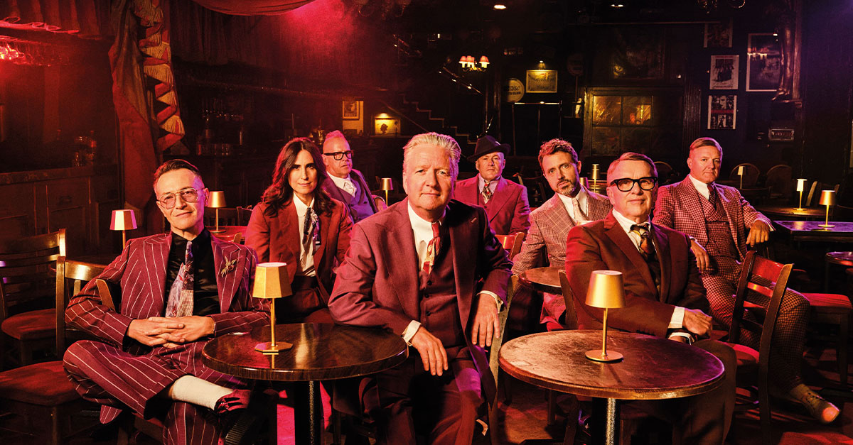 Several individuals dressed in suits in a pub.