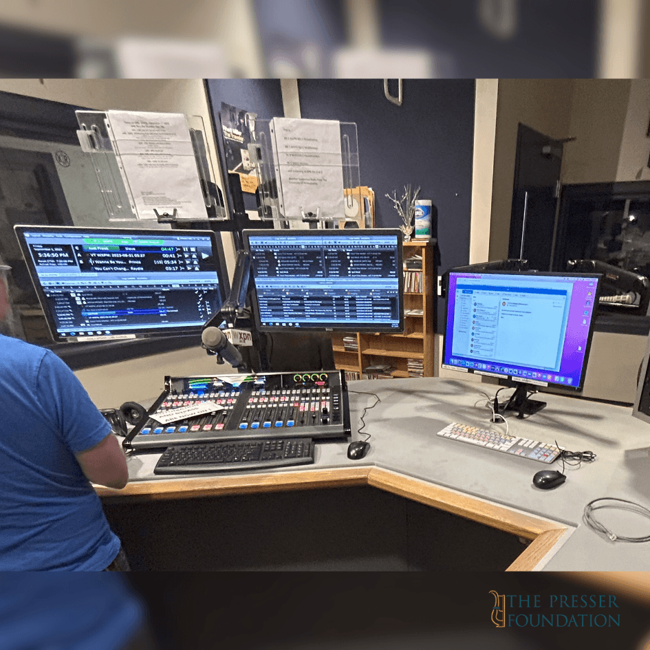 a radio board set up with three monitors, a switch board, two computer mouses, and a keyboard.